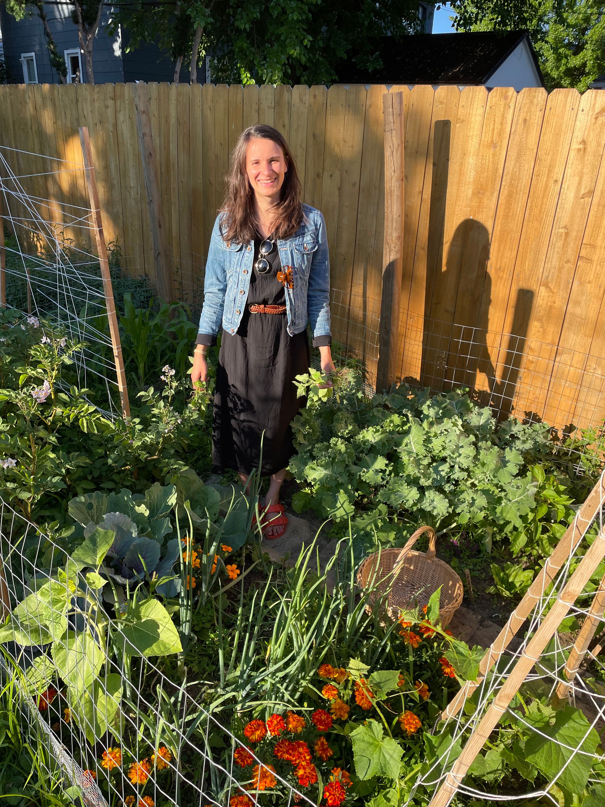 Beal in her garden, smiling in the late afternoon sun.