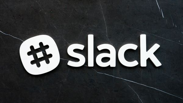 The Slack logo with hashtag in white, against a cracking marble background.
